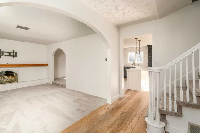 a view of a room with wooden floor & wall painting