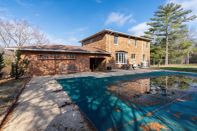 a building outdoor space with patio furniture and garden view