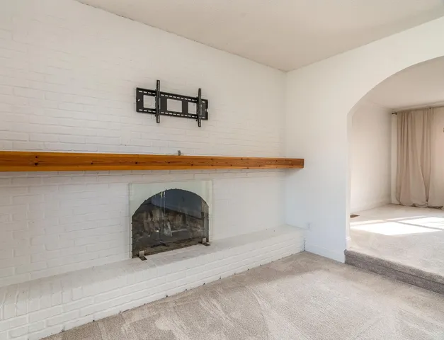 a view of a livingroom with a fireplace and a couch