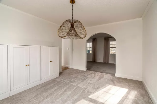 a view of a room with lots of windows and white walls