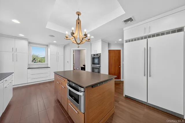a kitchen with a stove a refrigerator and a table