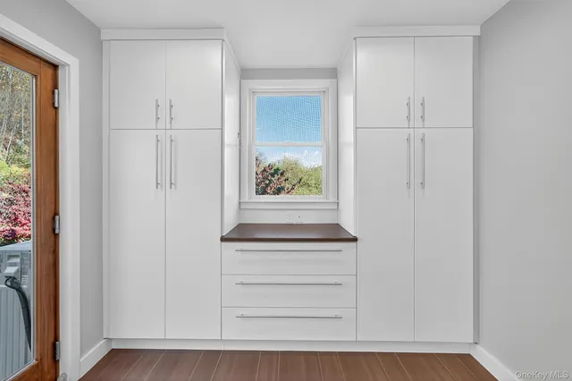 a view of an entryway with wooden floor