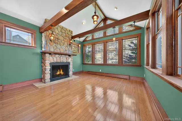 a view of an empty room with a fireplace and a window