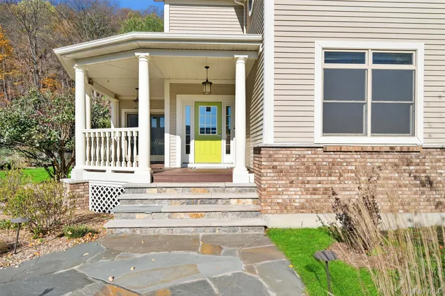 a front view of a house with a garden