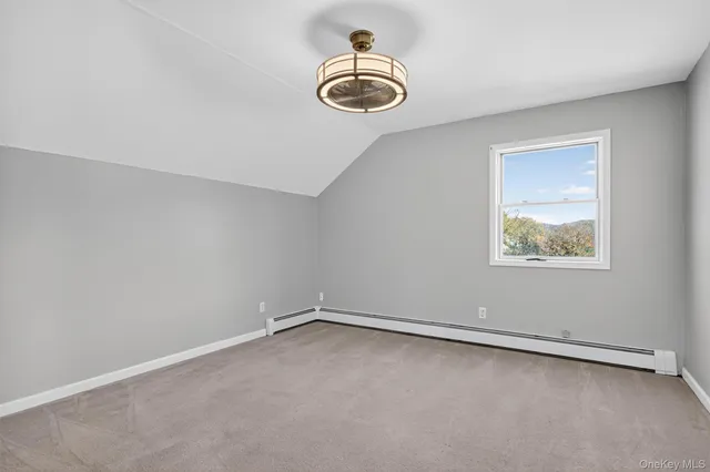 an empty room with a ceiling fan and window