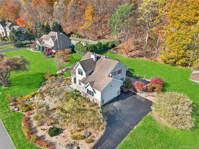 an aerial view of a house with garden space and trees