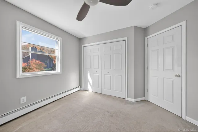 a lush green field with some trees in the background