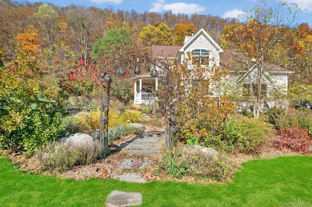 a aerial view of a house with a yard and large trees