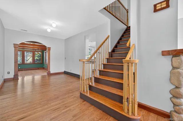 a view of entryway and hall with wooden floor