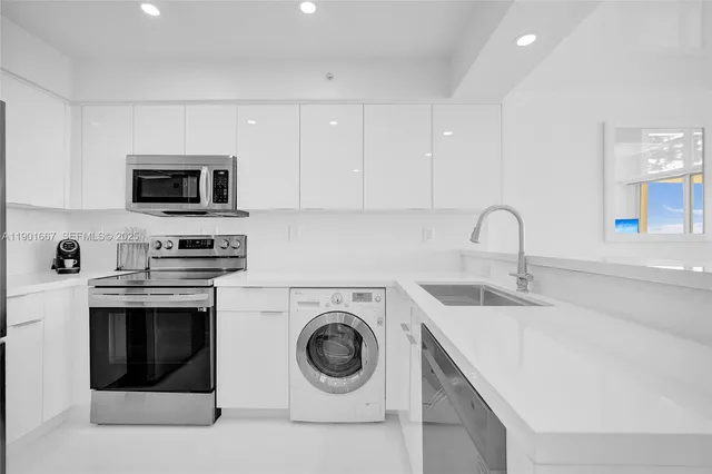 a kitchen with a sink a stove and cabinets