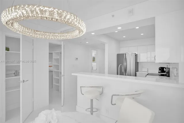 a kitchen with stainless steel appliances granite countertop a sink and refrigerator