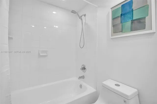 a bathroom with a bathtub a toilet and a shower