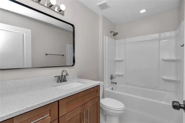 an empty room with chandelier fan