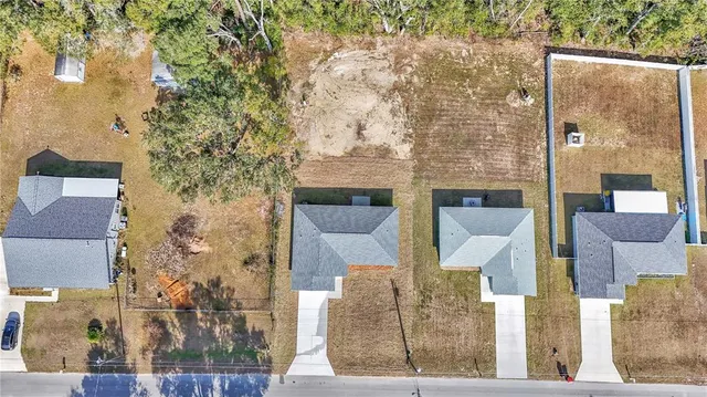 a view of multiple houses with yard