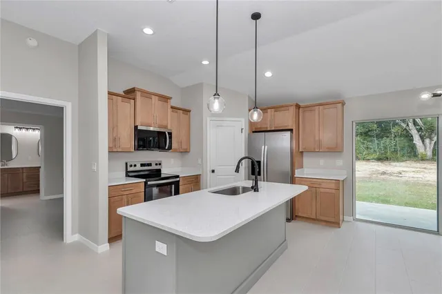 a kitchen with a sink and chandelier