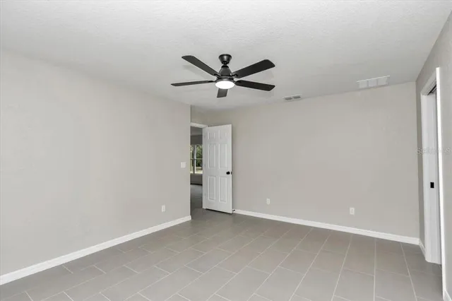 a view of a livingroom with a ceiling fan and a chandelier fan