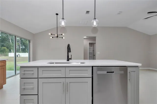 a kitchen with sink and refrigerator