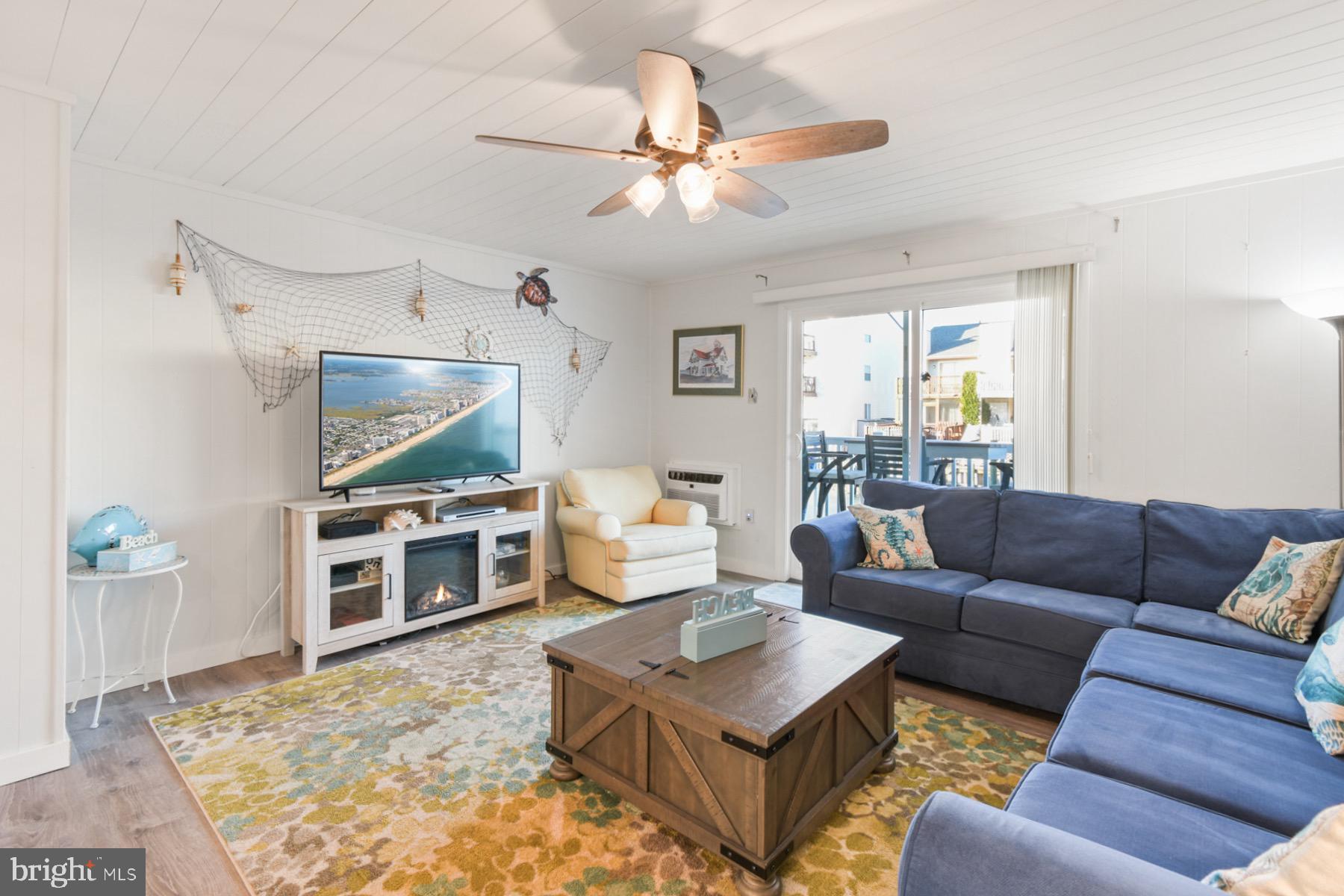 722 Mooring Road, Unit A104 Ocean City, MD 21842 - Photo 13 of 33 a living room with furniture and a flat screen tv