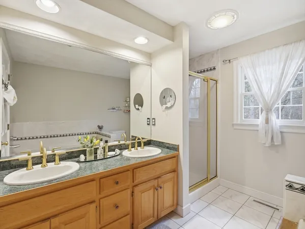 a spacious bathroom with a granite countertop sink and a mirror