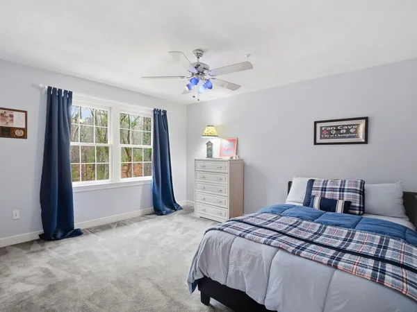 a bedroom with a bed dresser and a window