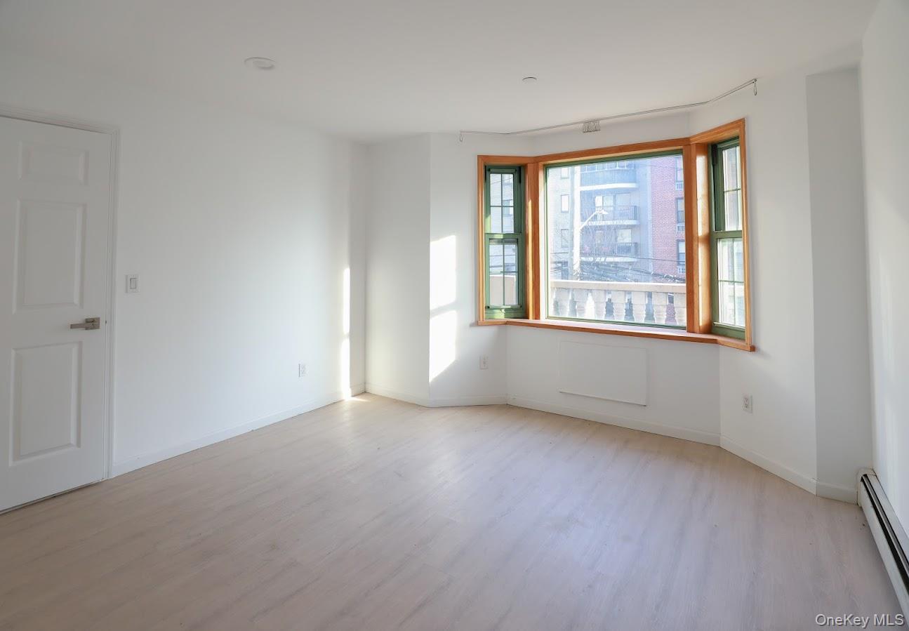 134-43 Maple Avenue, Unit 2A Queens, NY 11355 - Photo 13 of 15 an empty room with a window