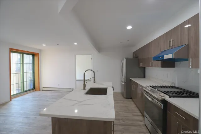 a kitchen with a sink stainless steel appliances and cabinets