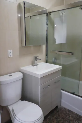 a bathroom with a sink mirror vanity and toilet
