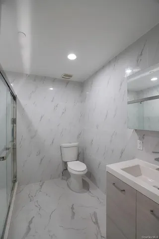 a bathroom with a sink a toilet and a shower