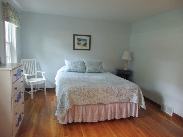 4 Stage Coach Road Harwich, MA 02645 - Photo 13 of 34 a bedroom with a bed and wooden floor