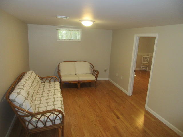 4 Stage Coach Road Harwich, MA 02645 - Photo 17 of 34 a bedroom with a bed and a chair