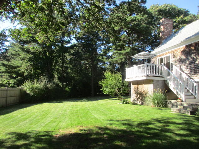 4 Stage Coach Road Harwich, MA 02645 - Photo 3 of 34 a view of backyard of house with green space