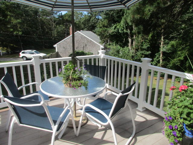 4 Stage Coach Road Harwich, MA 02645 - Photo 4 of 34 a view of a chairs and table in the patio