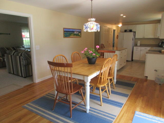4 Stage Coach Road Harwich, MA 02645 - Photo 5 of 34 a view of a dining room with furniture and wooden floor