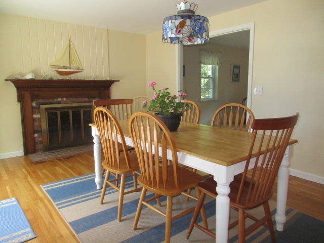 4 Stage Coach Road Harwich, MA 02645 - Photo 8 of 34 a view of a dining room with furniture wooden floor and a chandelier