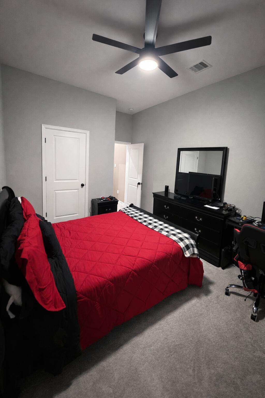 4334 Redford Valley Road Rosharon, TX 77583 - Photo 17 of 44 a bedroom with a bed and a chandelier