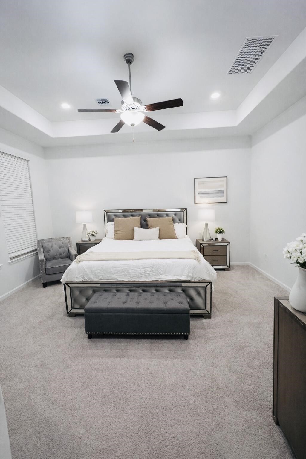4334 Redford Valley Road Rosharon, TX 77583 - Photo 34 of 44 a spacious bedroom with a bed and a ceiling fan