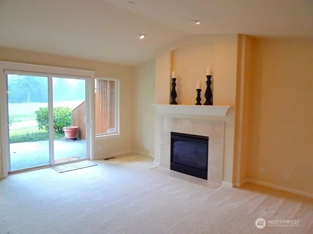 a view of empty room with a fireplace