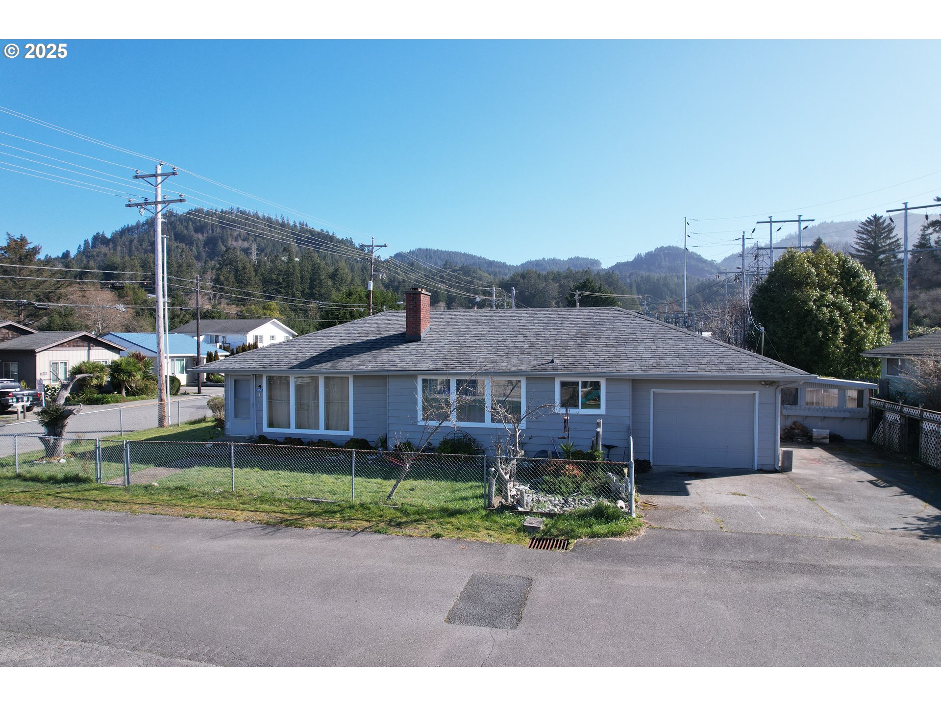 29545 Bailor Street Gold Beach, OR 97444 - Photo 1 of 48 a view of a house with a garden and pathway