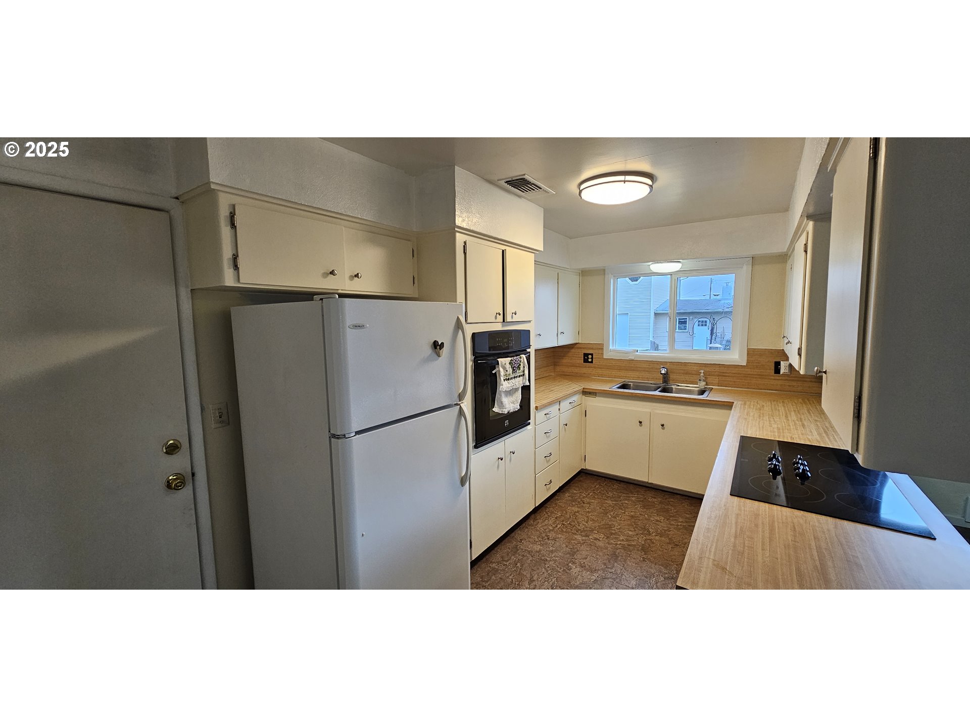 29545 Bailor Street Gold Beach, OR 97444 - Photo 22 of 48 a kitchen with a sink a refrigerator a window and a counter