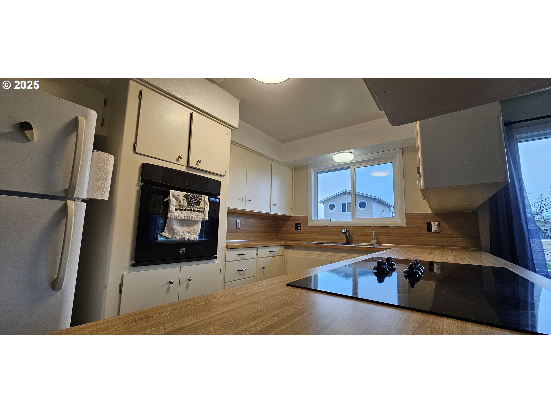 29545 Bailor Street Gold Beach, OR 97444 - Photo 23 of 48 a kitchen with stainless steel appliances a sink a stove a microwave a refrigerator a counter top space and cabinets