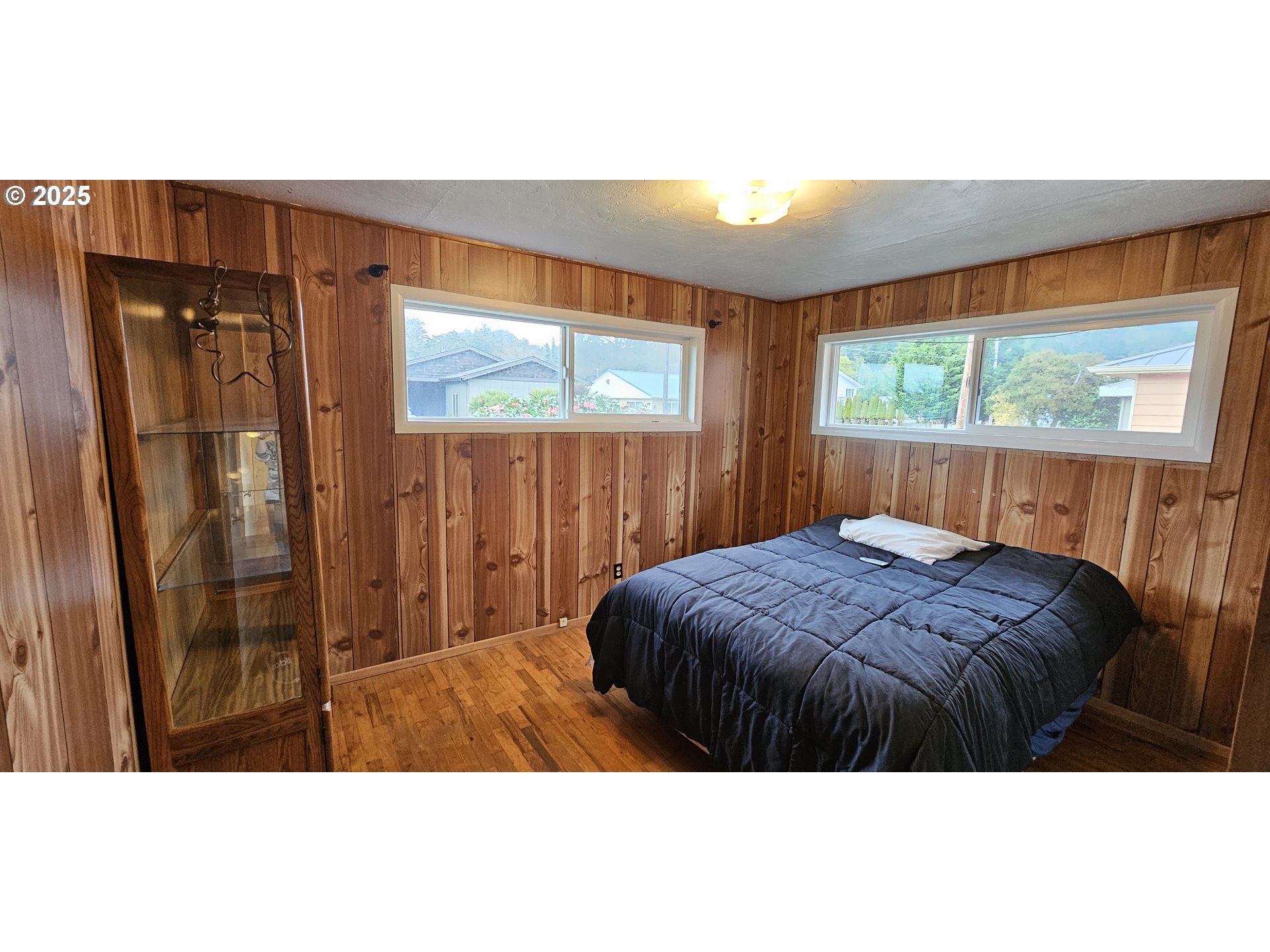 29545 Bailor Street Gold Beach, OR 97444 - Photo 24 of 48 a bedroom with a bed window and a bed