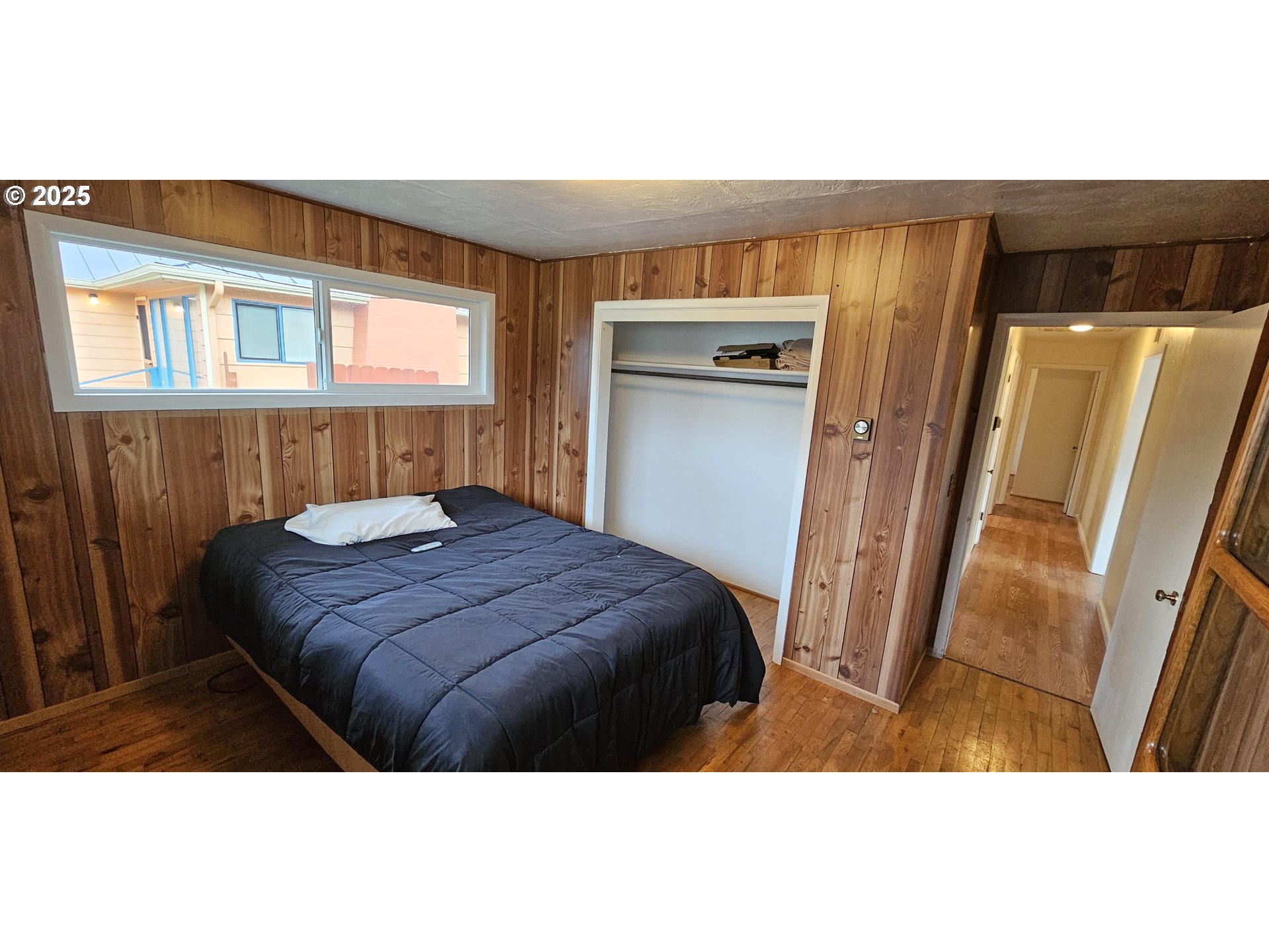 29545 Bailor Street Gold Beach, OR 97444 - Photo 26 of 48 a bedroom with a bed and a mirror