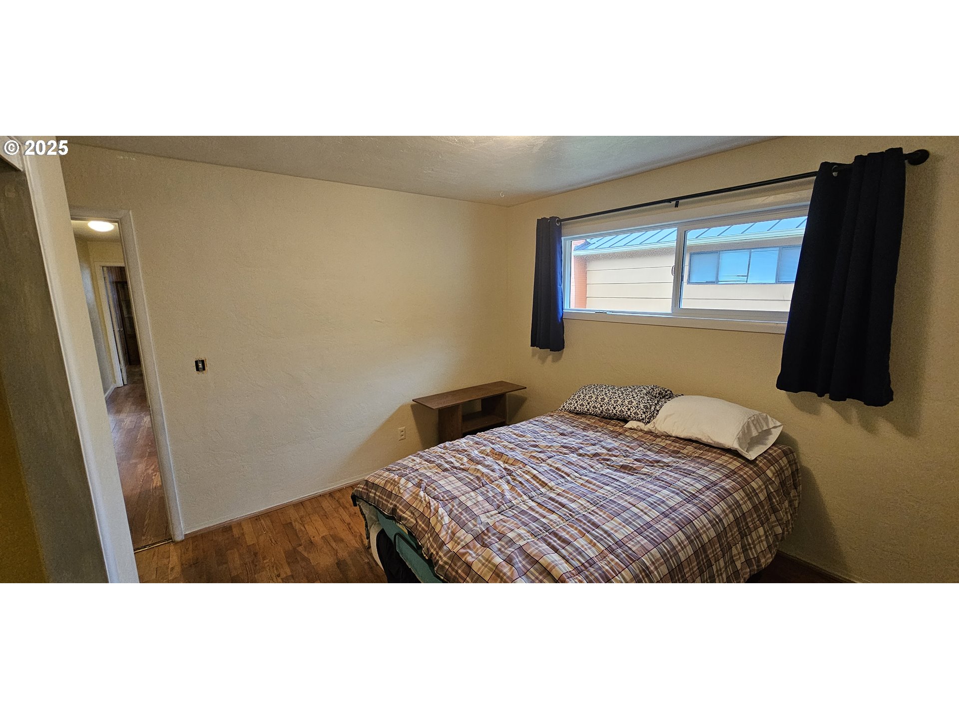 29545 Bailor Street Gold Beach, OR 97444 - Photo 37 of 48 a bedroom with a bed and a flat screen tv