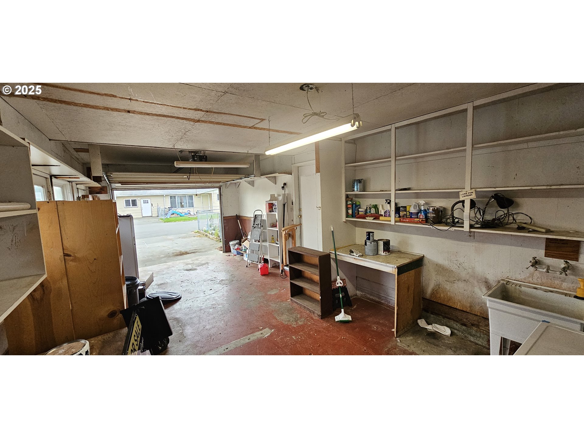 29545 Bailor Street Gold Beach, OR 97444 - Photo 40 of 48 a living room with furniture a rug and kitchen view