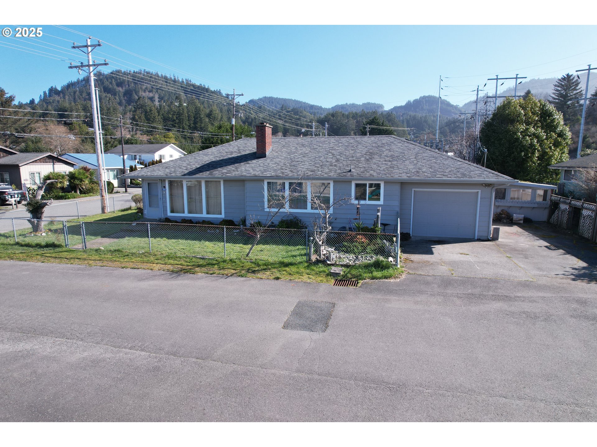 29545 Bailor Street Gold Beach, OR 97444 - Photo 7 of 48 a view of a house with a yard and potted plants