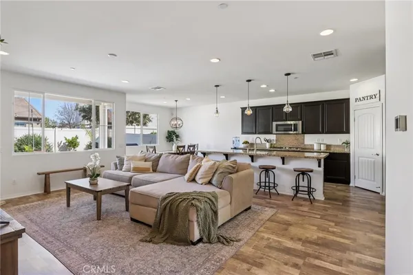 a living room with lots of furniture and kitchen view