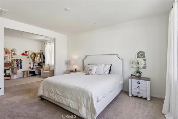 a bedroom with furniture and a book shelf