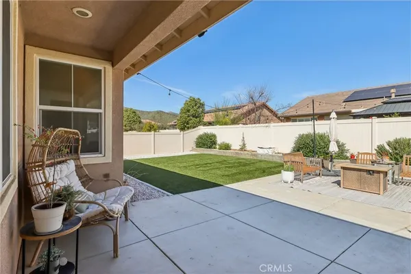 a view of a patio with table and chairs and potted plants