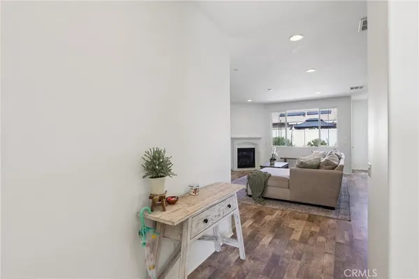a dining room with furniture a chandelier and wooden floor