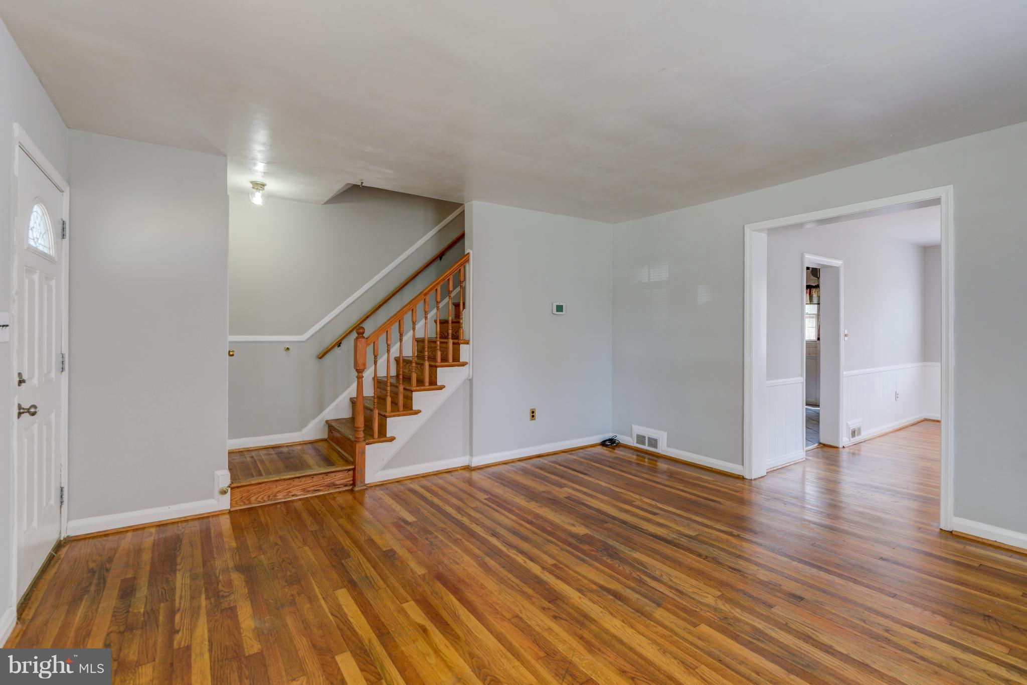 1265 Cedarcroft Road Baltimore, MD 21239 - Photo 7 of 21 a view of empty room with wooden floor and fan